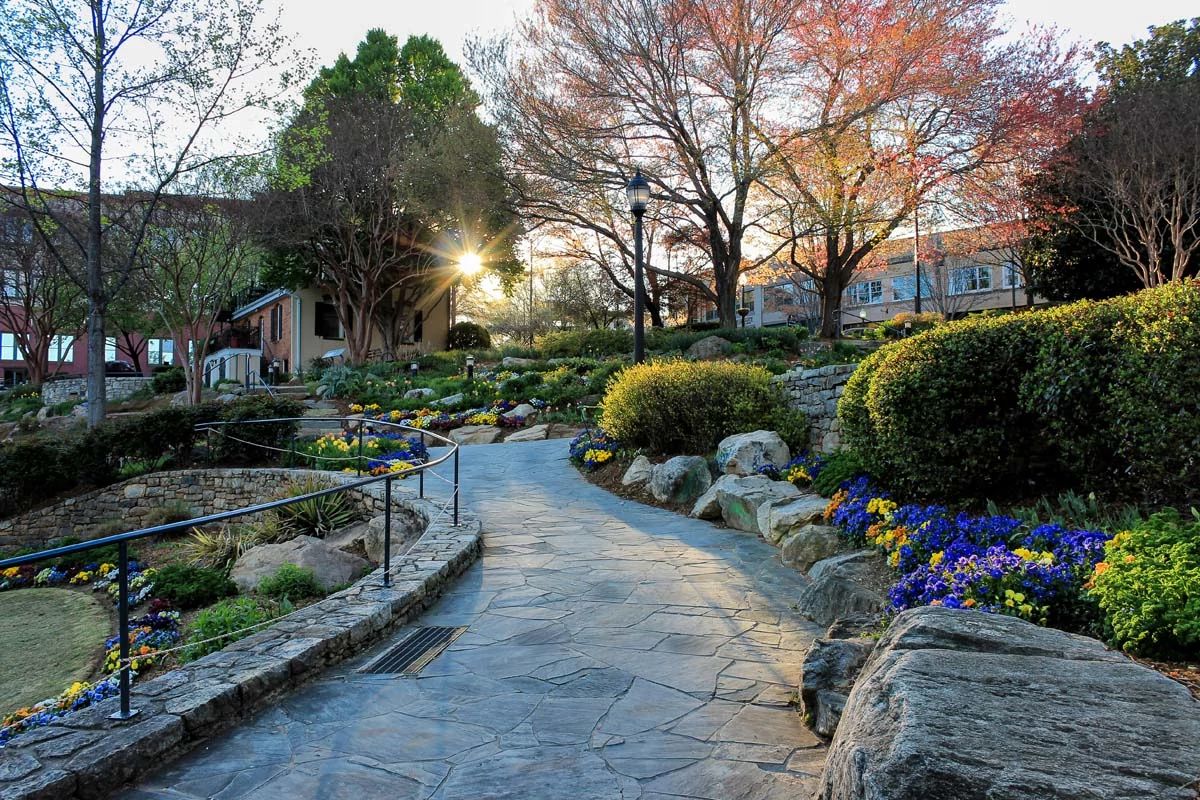 Beautiful Greenville downtown Falls park at the Reedy at golden hour with the Sun shining through the tree